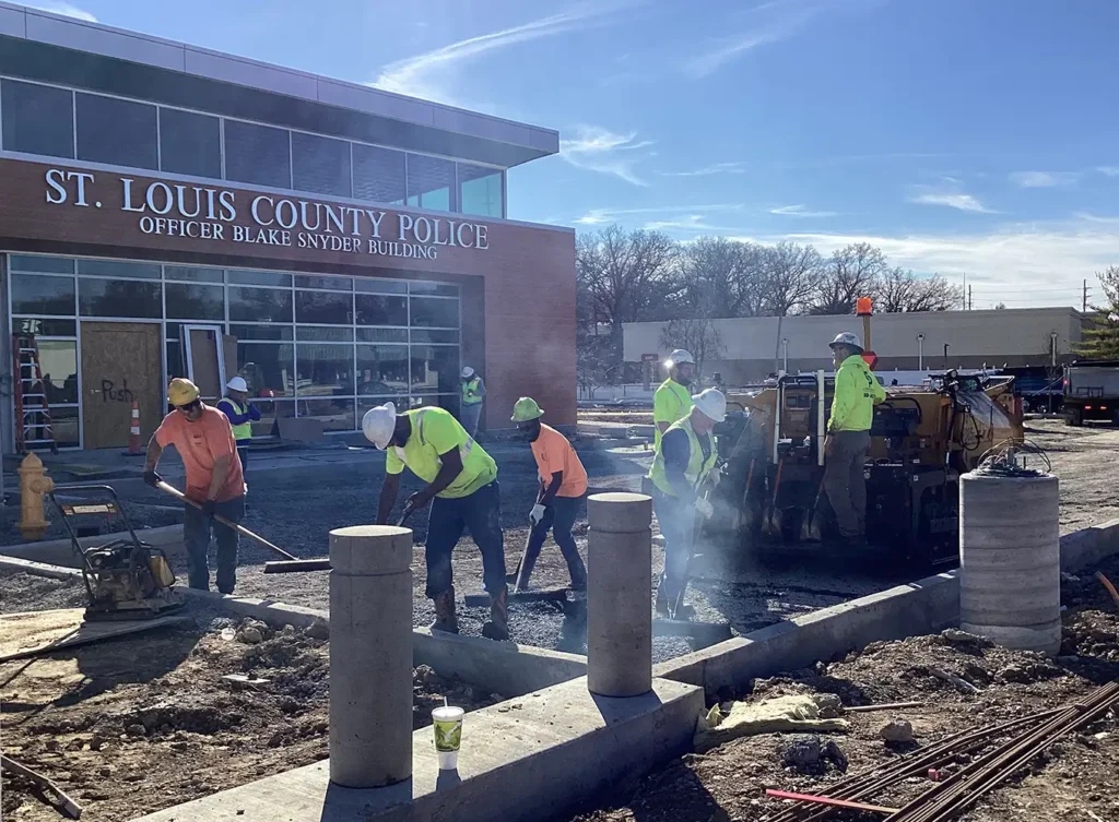 crew from brewster companies working on paving asphalt in front of a municipal building in st. louis mo